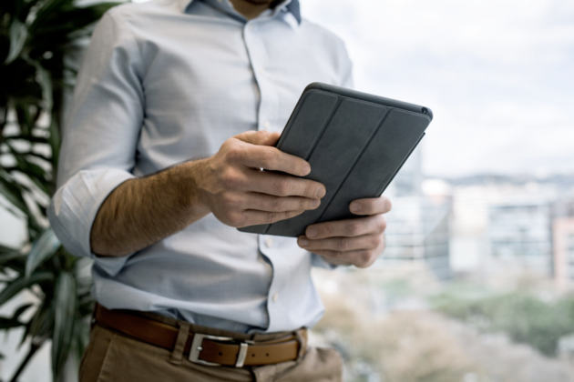 Image of a man holding an iPad