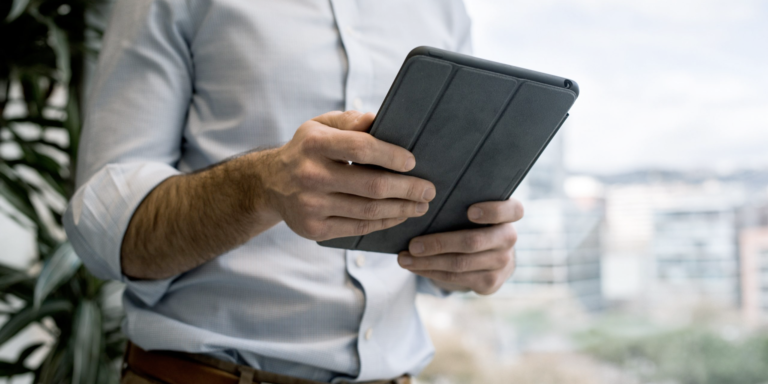 Image of a man holding an iPad